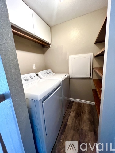 A small laundry room with a washer and dryer.