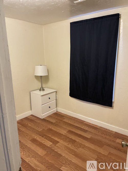 A room with a lamp and a drawer unit.