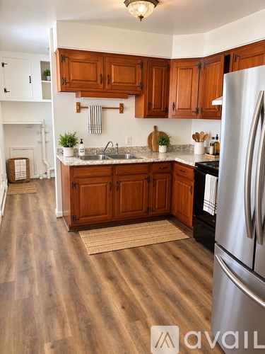 A kitchen with wooden cabinets and a white refrigerator.