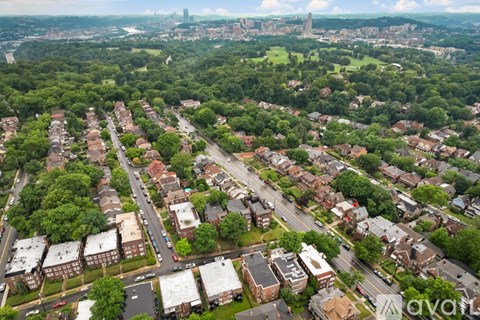 A bird's eye view of a residential area with houses and trees.