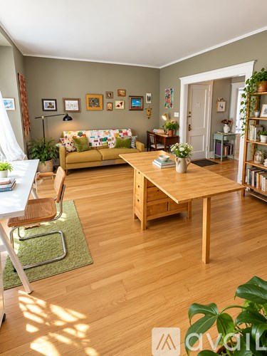 A living room with a couch, chair, and bookshelf.