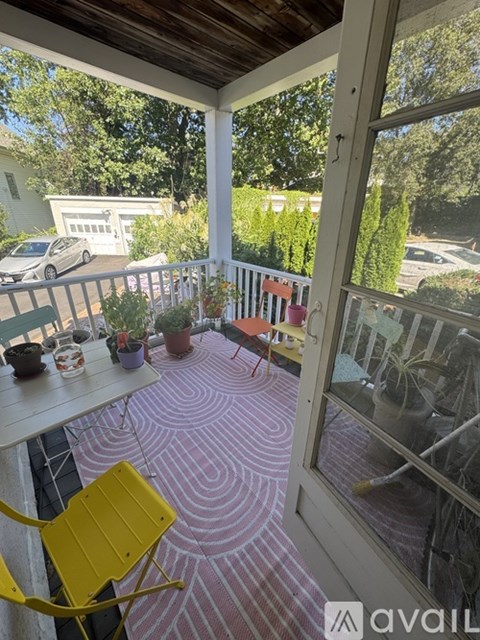A yellow chair is on a patio with a table and potted plants.