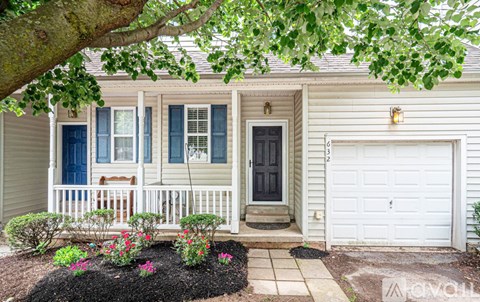 A house with a white garage door and a black front door.