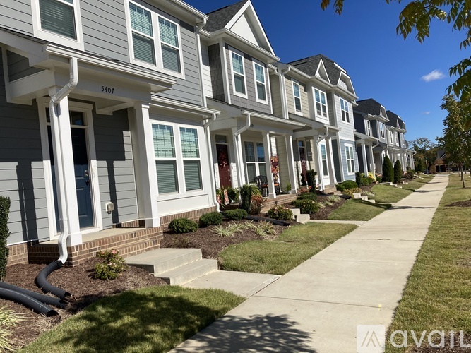 A row of houses with the number 54517 on the front of the first house.