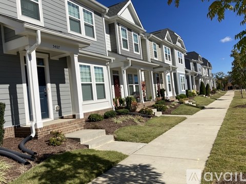 A row of houses with the number 54517 on the front of the first house.