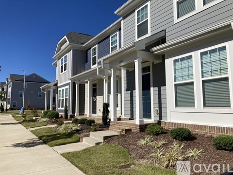 A row of houses with a clear blue sky above them.