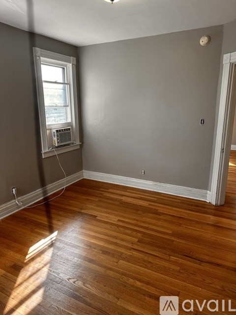 A room with wooden floors and a window.