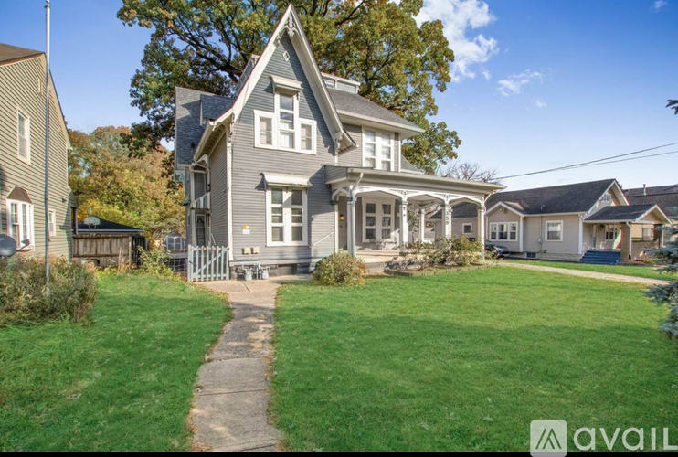 A house with a well-maintained lawn in front of it.