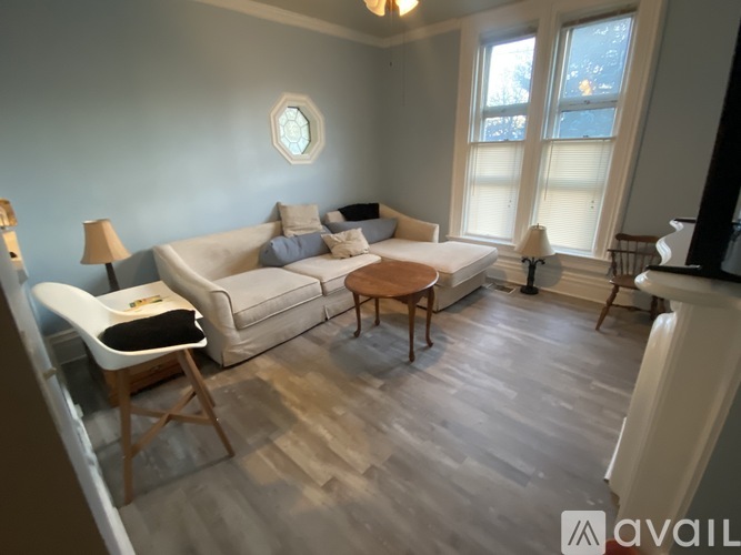 A living room with a white couch and a wooden coffee table.