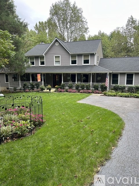 A house with a grey roof and a flag on the right side of the house.