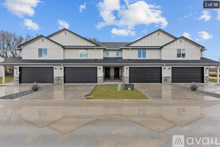 A large, two-story house with a garage is for sale.
