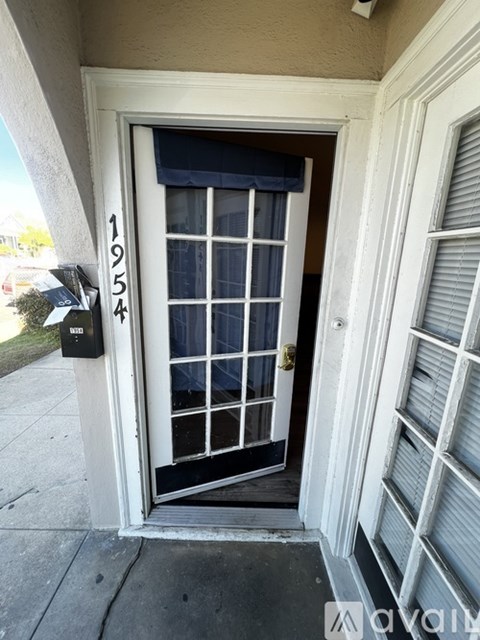 A door with a window and a mailbox on the wall.