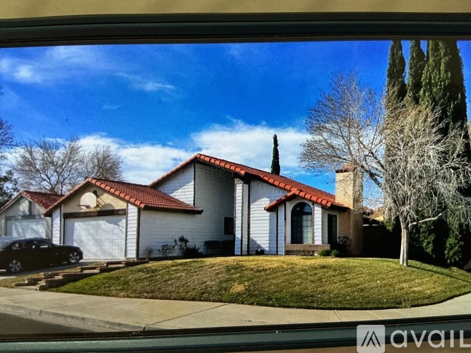 A house with a red tile roof is for sale.