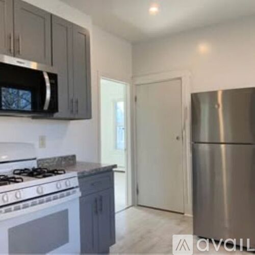 A kitchen with a stove top oven and a microwave.