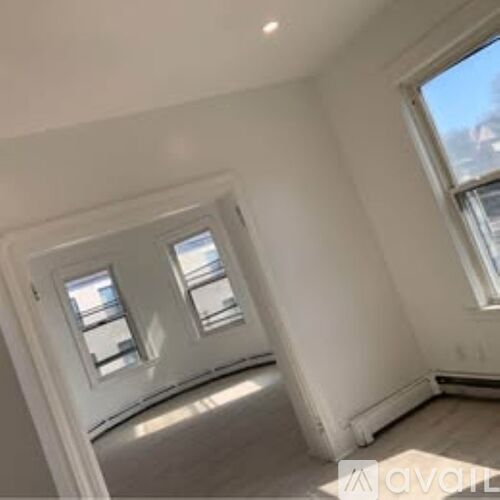 A room with two windows and a skylight.