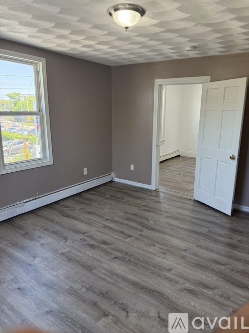 A room with a checkered ceiling and a window.