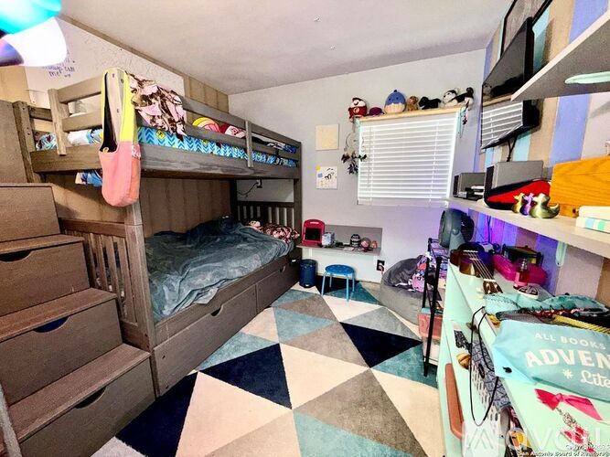 A room with bunk beds and a checkered floor.
