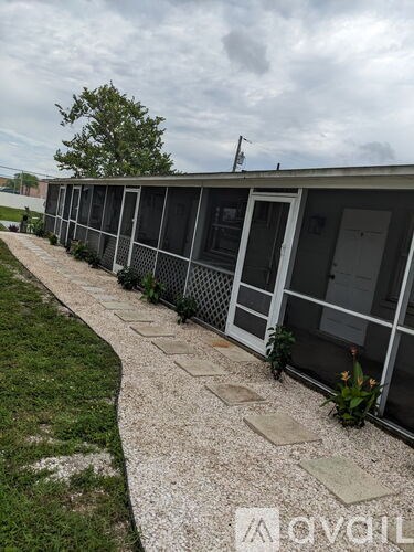 A row of houses with a grassy area in front.