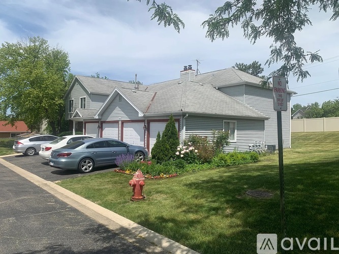 A house with a sign that says "NO PARKING ANYTIME" in front of it.