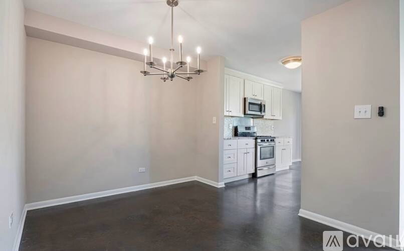 A kitchen with white cabinets and a microwave above the stove.
