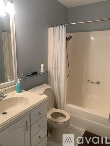 A bathroom with a toilet, sink, and shower.