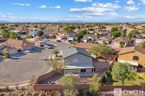 A bird's eye view of a neighborhood with houses and palm trees.