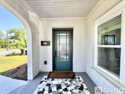 A house entrance with a black and white checkered mat.