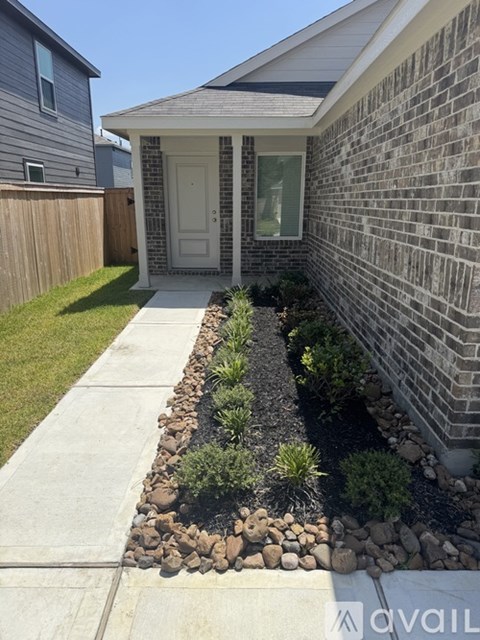 A house with a grey front yard and a white door.