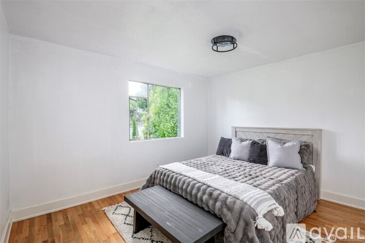 A bedroom with a large bed and a window.