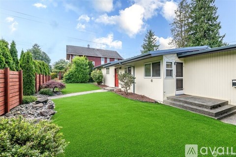 A house with a green lawn in front of it.