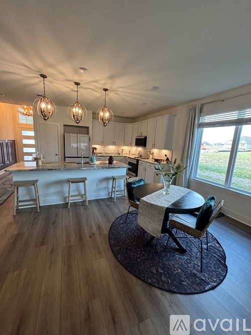 A kitchen with a bar area and a dining table.