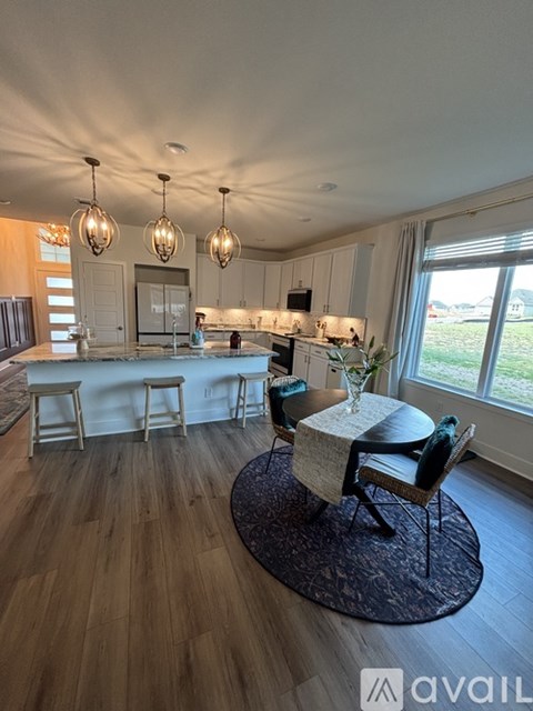 A kitchen with a bar area and a dining table.