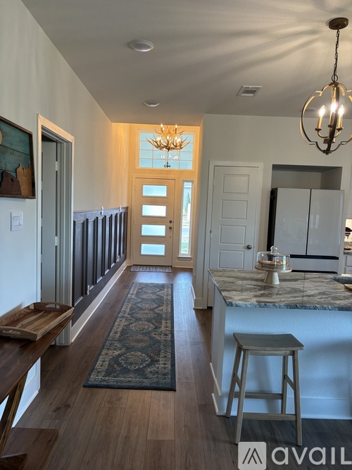 A kitchen with a bar stool and a counter.