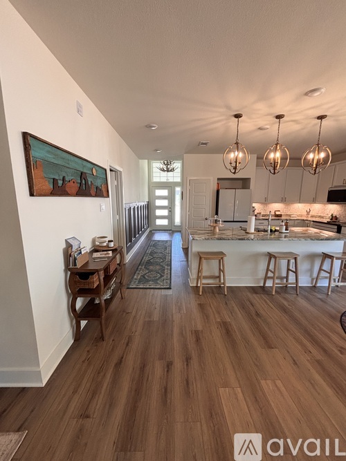 A kitchen with a bar and stools is available for rent.