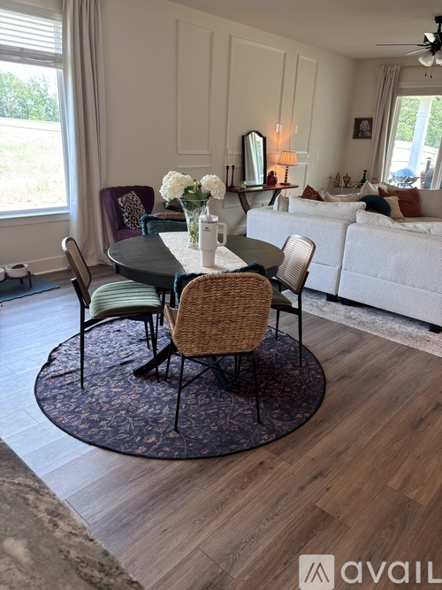 A dining table with chairs around it in a room.
