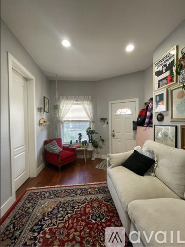 A living room with a red couch and a white couch.