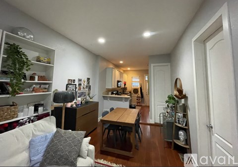 A living room with a couch, a table, and a bookshelf.