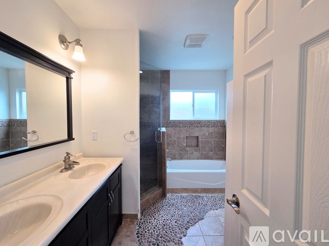 A bathroom with a white sink and a mirror.