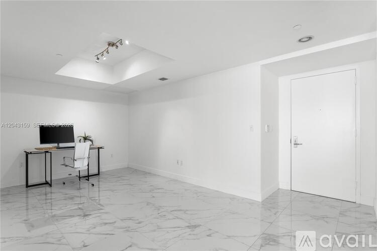 A room with a desk and a chair in it.