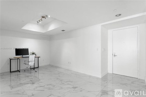 A room with a desk and a chair in it.