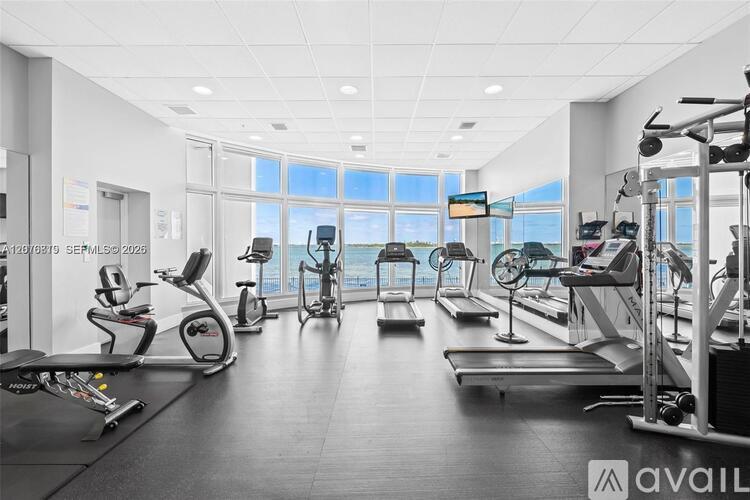 A gym with treadmills, exercise bikes, and other equipment.
