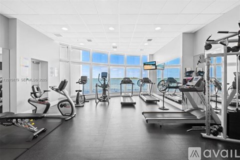 A gym with treadmills, exercise bikes, and other equipment.