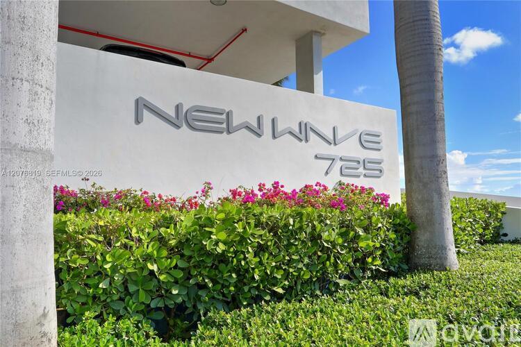 A white building with the words "New Wave 725" on it.