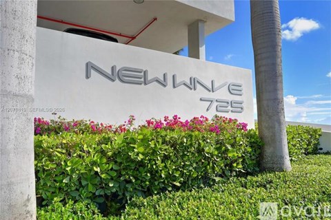 A white building with the words "New Wave 725" on it.