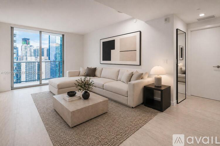 A modern living room with a large window overlooking a cityscape.