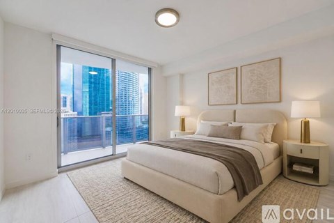 A bedroom with a large bed and a view of the city.
