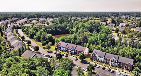 A bird's eye view of a residential area with houses and trees.