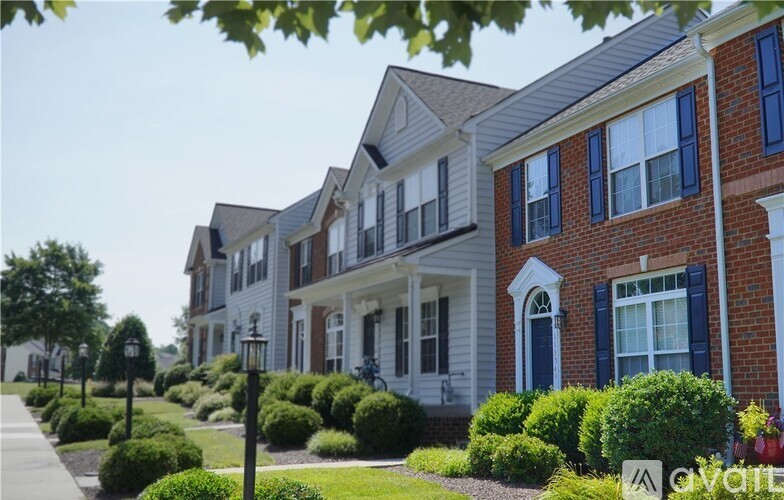 A row of houses with blue shutters and white trim.