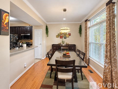 A dining room with a table set for four.