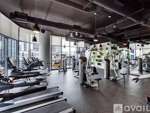 A gym with treadmills, weights, and exercise equipment.